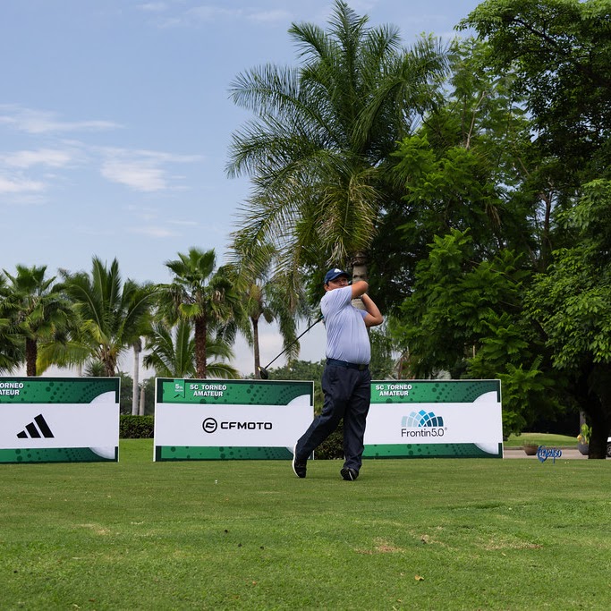 Golfer hitting a drive from a tee box with sponsor signage at Chanks Golf