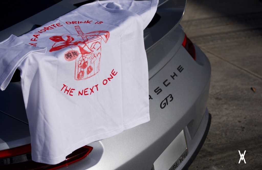 Over You graphic t-shirt laid over the back of a Porsche GT3