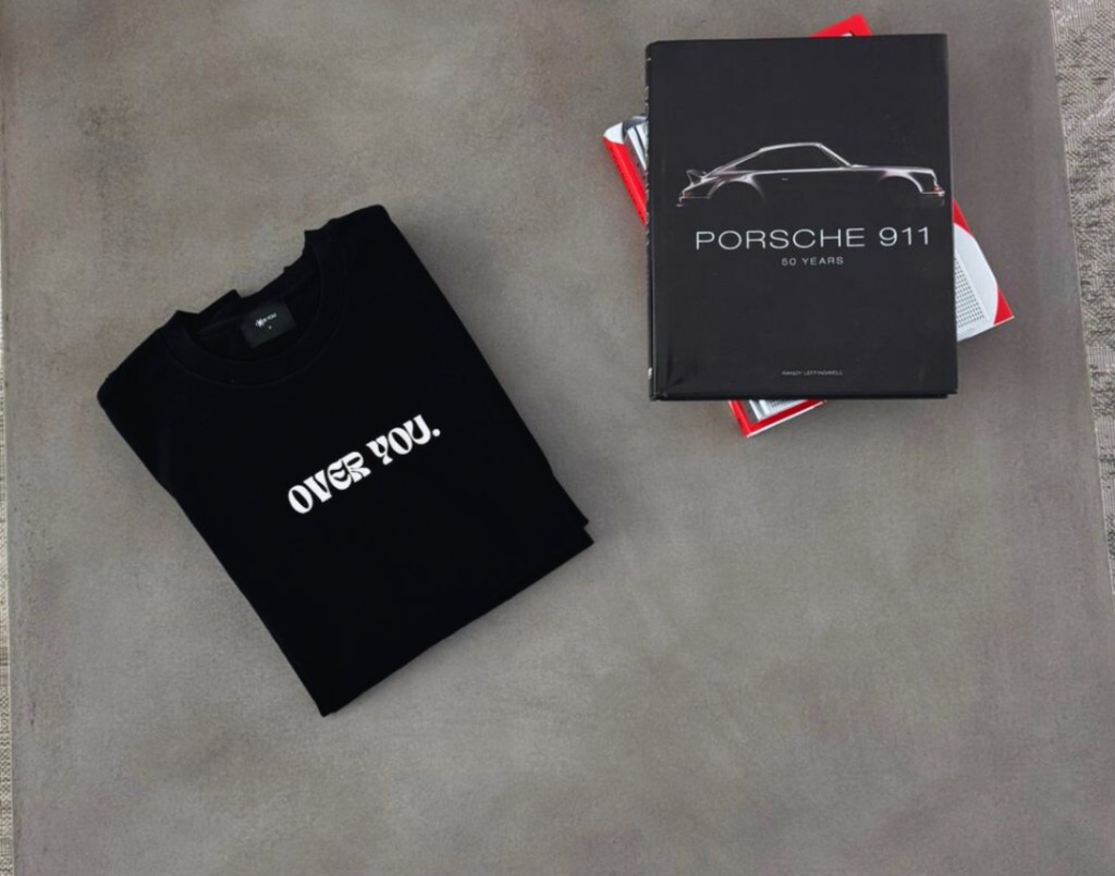 Folded Over You shirt next to Porsche 911 book